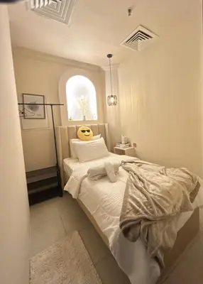 a bedroom with a bed and a window at Adaz Home in Dubai