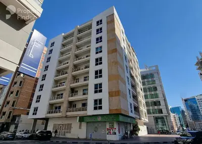 a tall white building on a city street at Adaz Home in Dubai