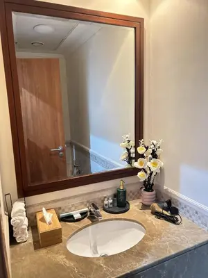 a bathroom with a sink and a large mirror at Adaz Homes in Dubai