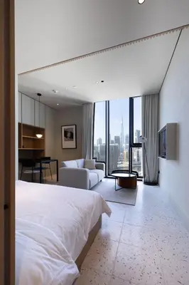 a bedroom with a bed and a living room at Modern Studio at Upside Living with Burj Views - Business Travelers in Dubai
