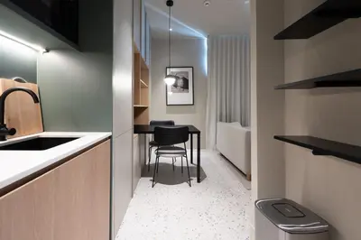 a small kitchen with a table and a stool at Modern Studio at Upside Living with Burj Views - Business Travelers in Dubai