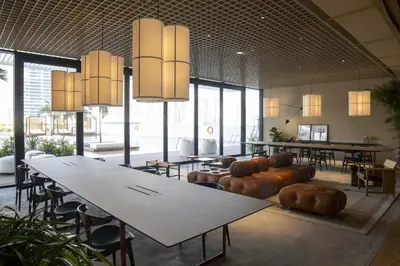 a large room with tables and chairs and large windows at Modern Studio at Upside Living with Burj Views - Business Travelers in Dubai