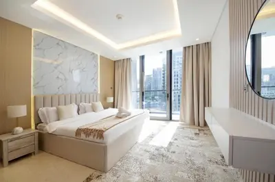 a bedroom with a large bed and a large window at Luxury 2BHK Plus Maid's Room The Sterling West Near Dubai Mall in Dubai