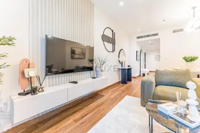 a living room with a large flat screen tv at Upgraded 2BR with Partial Sea and City Views Near the Beach, Elite Residence, Dubai Marina by Deluxe Holiday Homes in Dubai