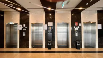 a lobby with four elevators in a building at Cozy 1Bed Sports city in Dubai