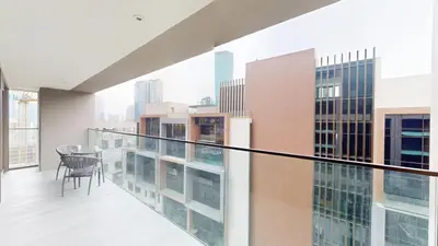 a balcony with a table and chairs on a building at Peninsula - Modern Two Bedroom in Business Bay in Dubai