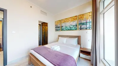 a bedroom with a bed and a window at Torch Tower - One Bed with Skyline View in Marina in Dubai