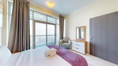 a bedroom with a large bed with a large window at Torch Tower - One Bed with Skyline View in Marina in Dubai