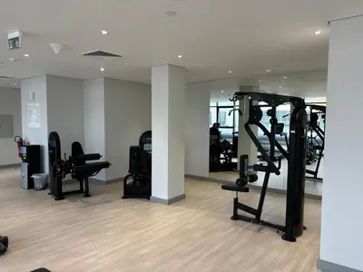 a gym with treadmills and exercise equipment in a building at Meydan Riviera Midtown Comfort Studio in Dubai