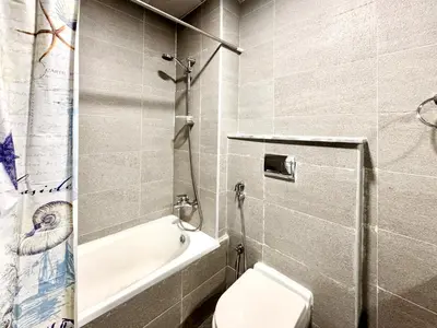 a bathroom with a toilet and a tub and a sink at Al Manara Premium Cozy Studio in Dubai