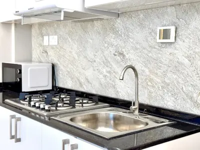 a kitchen with a sink and a stove at Al Manara Premium Lux Studio in Dubai