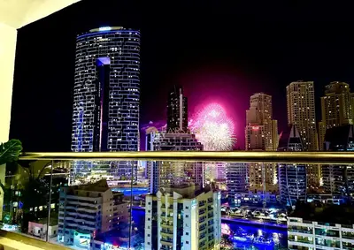 a view of a city skyline at night with fireworks at Barsana - Seaside Luxury 2BDR - Panoramic Marina & Sea Views in Dubai