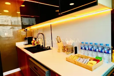 a kitchen counter with a sink and a tray of water bottles at Barsana - Seaside Luxury 2BDR - Panoramic Marina & Sea Views in Dubai