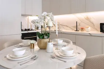 a white table with utensils on it in a kitchen at 1 Bedroom Marina with Canal View in Dubai