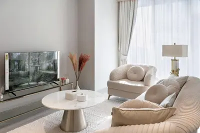 a living room with a couch and a tv at 1 Bedroom Marina with Canal View in Dubai