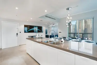 a white kitchen with a sink and a tv at Ultimate 5BR Luxury I 2500 sqf I Burj Inner Circle in Dubai