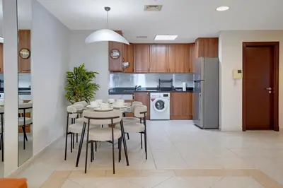 a kitchen and dining room with a table and chairs at 28- Luxury Princess Tower Marina Apartment with Sea View, Pool & Balcony in Dubai