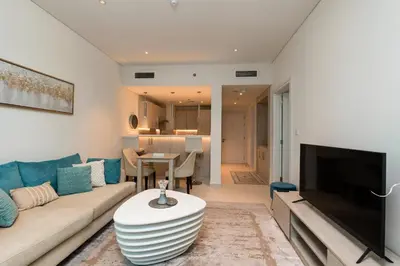 a living room with a couch and a table at Elegant 1-BR with Sea View Seven Palm, Palm Jumeirah in Dubai