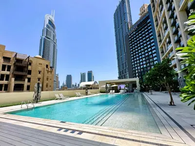 a swimming pool in a city with tall buildings at Burj Royale Suites by Prestige Nest in Dubai