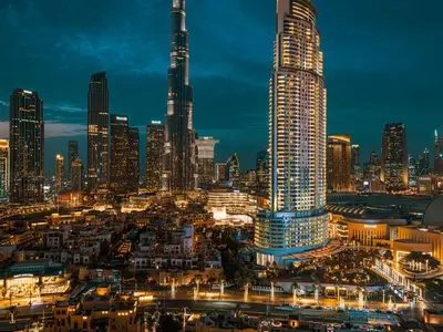 a city skyline at night with tall skyscrapers at Burj Royale Suites by Prestige Nest in Dubai