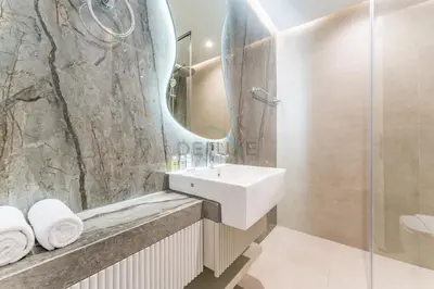a bathroom with a sink and a mirror at Redesigned High-Rise 1BR Near Key Landmarks, Elite Residence, Dubai Marina by Deluxe Holiday Homes in Dubai