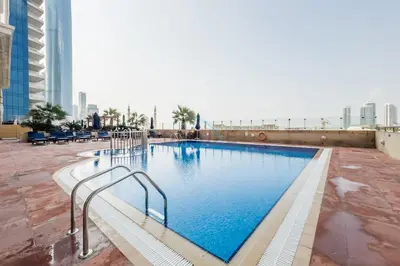 a large swimming pool on the roof of a building at Redesigned High-Rise 1BR Near Key Landmarks, Elite Residence, Dubai Marina by Deluxe Holiday Homes in Dubai