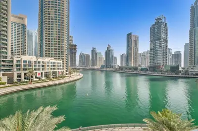 a river in the middle of a city with tall buildings at Luxury new studio Dubai Marina 10min to the beach in Dubai