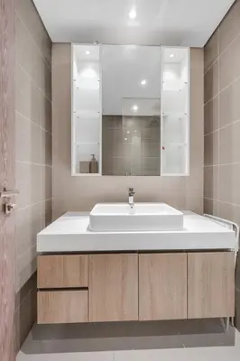 a bathroom with a white sink and a mirror at Luxury new studio Dubai Marina 10min to the beach in Dubai