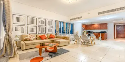a living room with a couch and a table at 1 BR Spacious Apartment - JLT in Dubai
