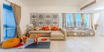 a living room with a couch and a table at 1 BR Spacious Apartment - JLT in Dubai