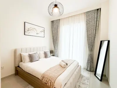 a bedroom with a large bed and a large window at Spacious 3BR, Private Beach Access in Dubai