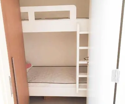 a room with two bunk beds with a ladder at Spacious 3BR, Private Beach Access in Dubai