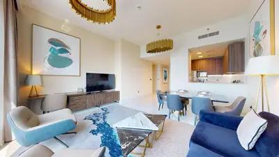 a living room with a couch and a dining room at Locations I Avani Palm View I Luxury 2 Bedroom I Sea View I Pool, Gym, Parking, Wi-Fi in Dubai