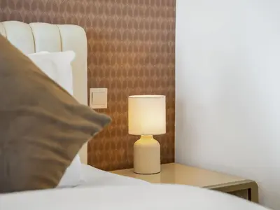 a lamp on a table next to a bed at Palm & Sea View Beach Acess JBR walk Skydive clubs in Dubai