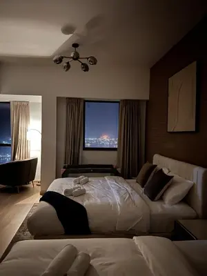 a bedroom with two beds and a large window at Palm & Sea View Beach Acess JBR walk Skydive clubs in Dubai