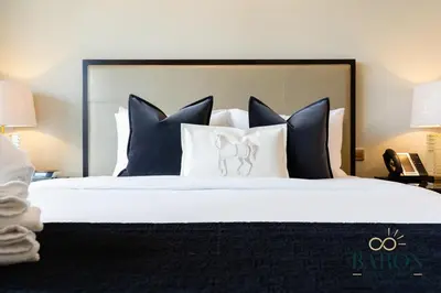 a bedroom with a large bed with black and white pillows at The Chic in Dubai
