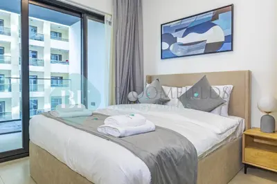a bedroom with a bed with a large window at Bloomfields Stylish 1Br In Binghatti Creek Jaddaf in Dubai