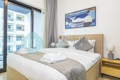 a bedroom with a large bed with a window at Bloomfields Stylish 1Br In Binghatti Creek Jaddaf in Dubai