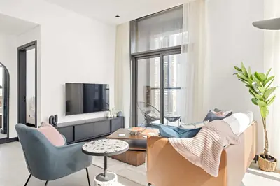 a living room with a couch and chairs and a tv at Silkhaus Highfloor 1BDR in 15 Northside Tower in Dubai
