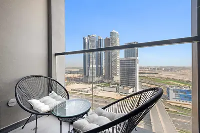 a balcony with two chairs and a glass table at Silkhaus Highfloor 1BDR in 15 Northside Tower in Dubai