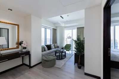 a living room with a bed and a mirror at Address Dubai Marina, Dubai Marina - Mint Stay in Dubai