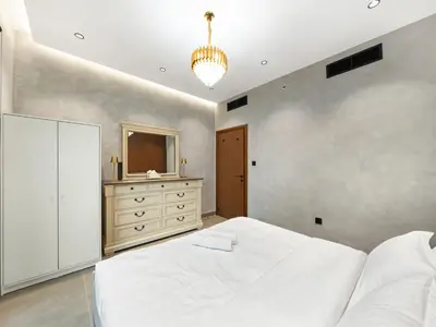 a bedroom with a bed and a dresser and a mirror at Luxury Apartment In the Heart of Dubai Marina in Dubai