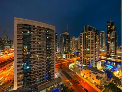 a view of a city at night with buildings at Luxury Apartment In the Heart of Dubai Marina in Dubai