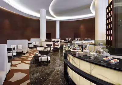 a restaurant with a bar and tables and chairs at Cosmos Living Studio at JW Marina in Dubai
