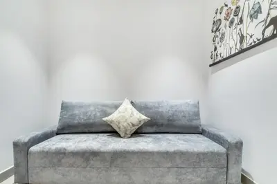 a gray couch with a pillow on it in a room at GuestReady - Panoramic views from One JBR in Dubai