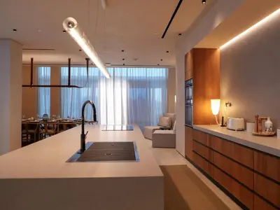 a kitchen and living room with a sink and a couch at High End 4BR Penthouse with Private Pool and Skyline Views in Dubai