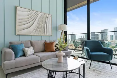 a living room with a couch and a table and chairs at GuestReady - Modern retreat in JVC in Dubai