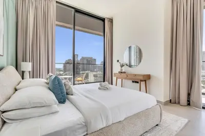a bedroom with a large bed with a large window at GuestReady - Modern retreat in JVC in Dubai