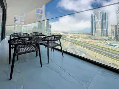 a balcony with chairs and a view of a city at Skyline Oasis - Business Bay with Burj Khalifa Vie in Dubai