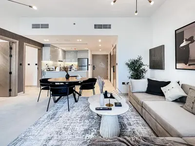 a living room with a couch and a table at Skyline Oasis - Business Bay with Burj Khalifa Vie in Dubai